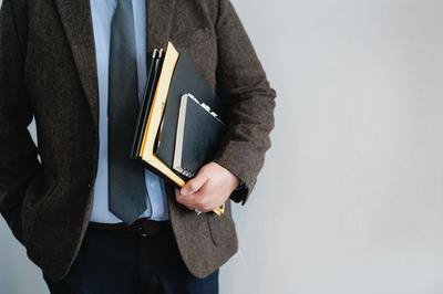 man in a suit carrying folders man in a suit carrying folders