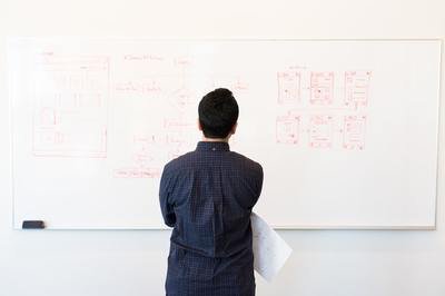 man in front of whiteboard