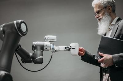 robot handing a man coffee